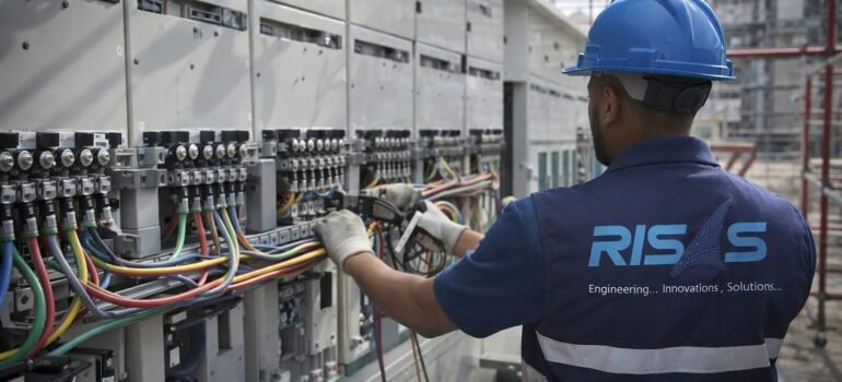 RISAS engineer performing electrical installation and cable connections in industrial facility in Saudi Arabia